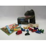 A collection of dinosaur toys including puppet, books, wooden toys etc