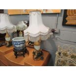 A pair of painted metal table lamps with gilt form fish and faux marble bases a/f