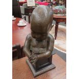 A bronzed resin sculpture on plinth of a small child. Overall height 43cm
