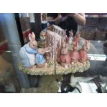 A pair of Border Fine Arts Beatrix Potter book ends featuring Mrs Rabbit, Peter Rabit, Flopsy, Mopsy