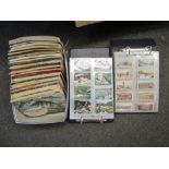 A box of Brooke Bond tea card albums and two cigarette card albums
