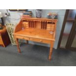 A natural pine Victorian style desk on turned leg supports, 108cm x 110cm x 65cm