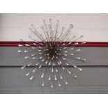 A modern sun burst style decorative wall hanging 77cm diameter