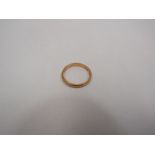 A 22ct gold wedding band, cut, 3 grams