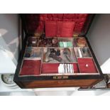 A Victorian walnut inlaid sewing box and contents