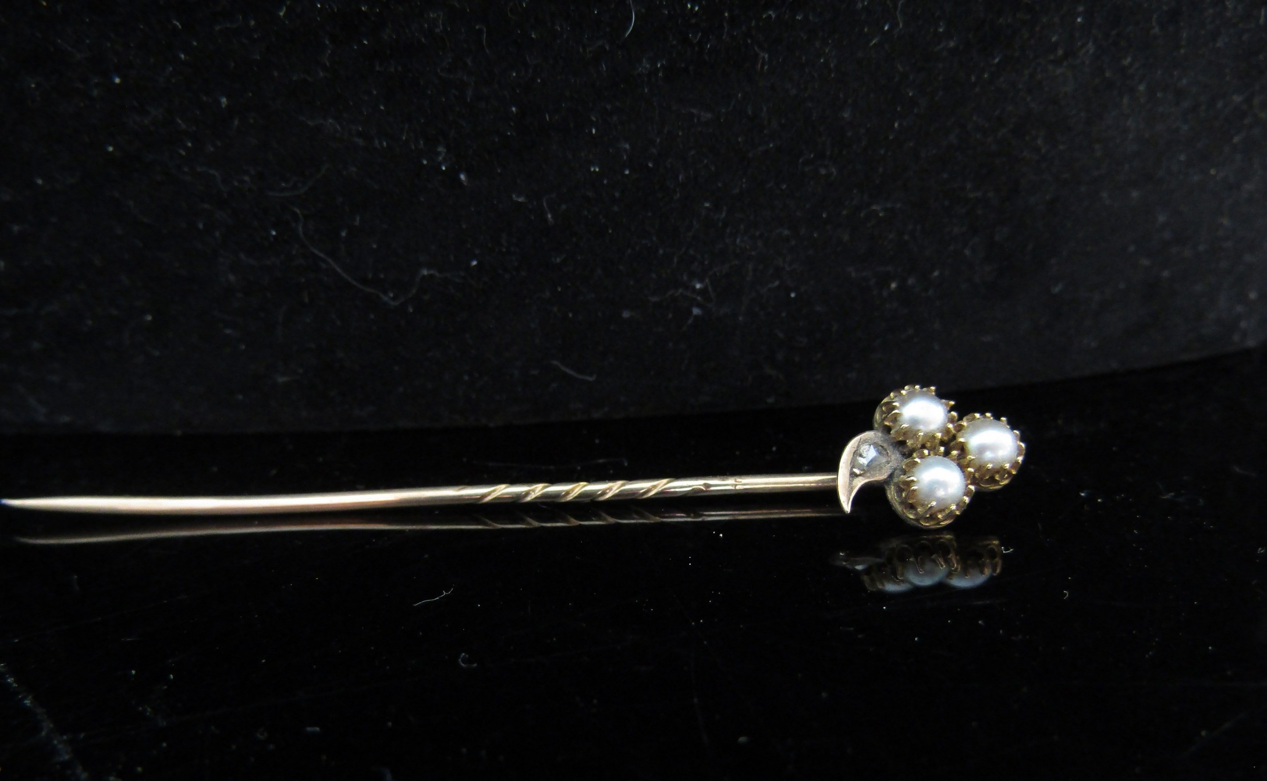 A pearl and old cut diamond set stick pin, unmarked, in fitted case, 2g