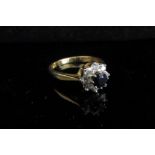 An 18ct gold sapphire and diamond cluster ring. Size M/N, 3.5g