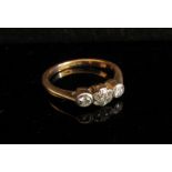 An 18ct gold platinum set three stone diamond ring in illusion setting. Size M, 2.8g