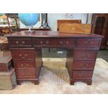 A reproduction eight drawer twin pedestal desk with leather tooled top. 76cm x 120cm x 60cm