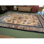 A large hand knotted wool Chinese rug in cream and blue tones, scenes of flora and fauna,