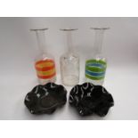 Three glass decanters including two with colourful band design and two frilled glass dishes