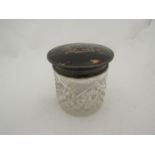 An Edwardian cut glass pot with silver and tortoiseshell lid