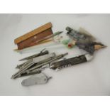 A box of miscellaneous including pen knives, glass cocktail stirers, wooden rules etc.