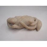 A late 19th Century carved stone rodent coiled by a serpent, 15cm long