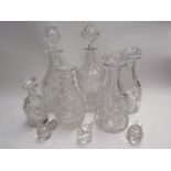 Six various cut glass decanters together with three stoppers