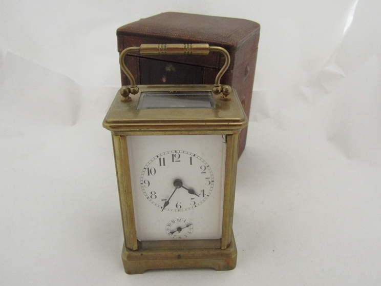 A late 19th early 20th Century brass carriage clock with alarm, red case a/f