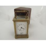 A late 19th early 20th Century brass carriage clock with alarm, red case a/f
