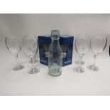 A set of six wine glasses, highball glasses and a milk bottle with relief design