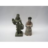 A carved stone Indian diety and Chinese wooden seated figure, 24cm x 22cm