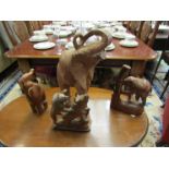 An Eastern carved hardwood elephant, two smaller carved elephants and a figural group of lion