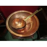 A hammered copper bowl and two brass handled pans (3) bowl 36.5cm diameter