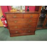 A late Victorian Arts and Crafts oak chest of two short over three graduating long drawers on a