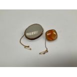 An Agate brooch of rounded rectangular form and an oval white agate brooch