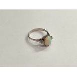 An 18ct white gold opal and diamond ring. Size K, 2.3g