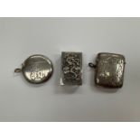 Two silver Vesta cases including foliate engraved and monogrammed circular example and a Chinese