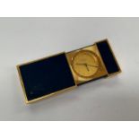 A Dupont of Paris travelling pocket alarm clock, gilt metal with blue panels