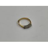 An 18ct gold graduated five stone diamond ring, size T, 3.8g