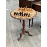 A Victorian walnut marquetry inlaid games table with chequerboard top, on tripod base, together with