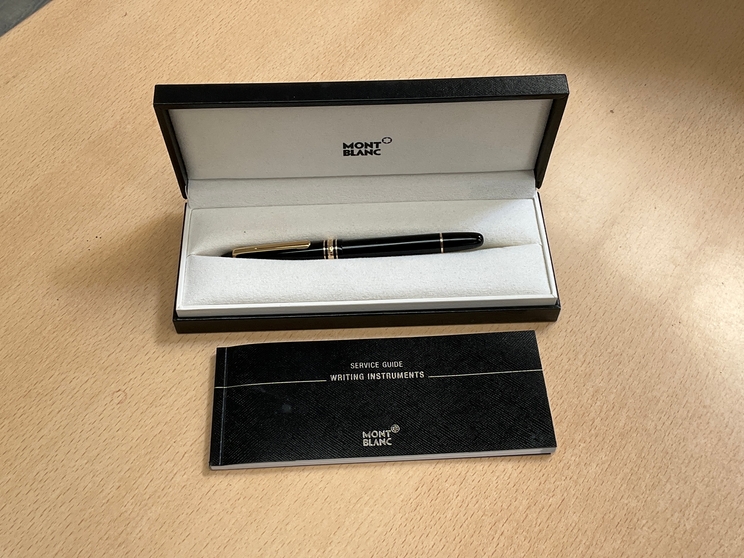 A Mont Blanc Classique fountain pen in black with gold detail, boxed with booklet