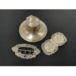 A silver capstan inkwell and two silver buckles (3)