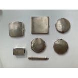 Five silver compacts including Art Deco, a silver matchbox cover and silver engraved pencil