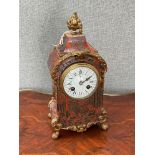 A 19th Century boullework clock, fruit finial over an ormolu mounted scrolled foliate case, on