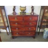 A George III mahogany straight front chest of two short over three long drawers with brass