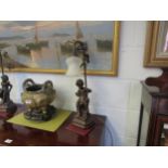 A pair of figural lamps of children with dogs