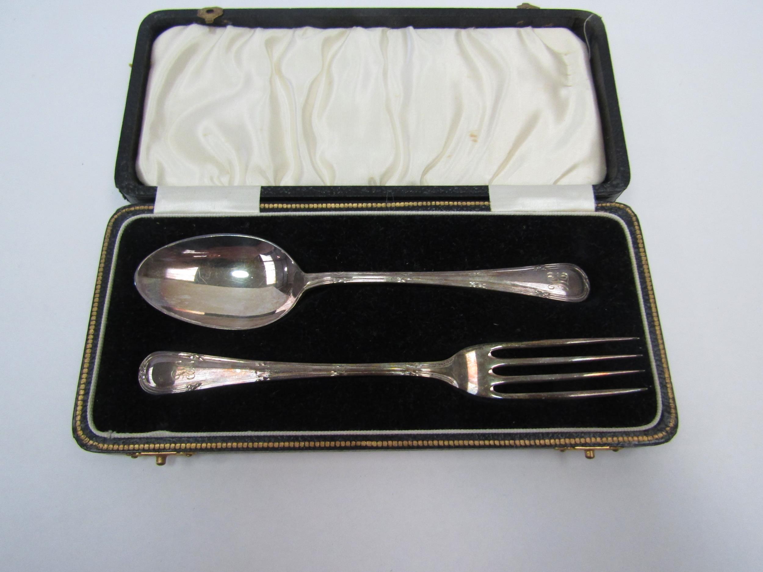 A silver two piece Christening spoon and fork set, monogrammed handles
