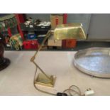 A brass adjustable desk lamp