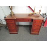 A 19th Century twin pedestal breakfront mahogany desk with tooled leather insert, 70cm x 120cm x