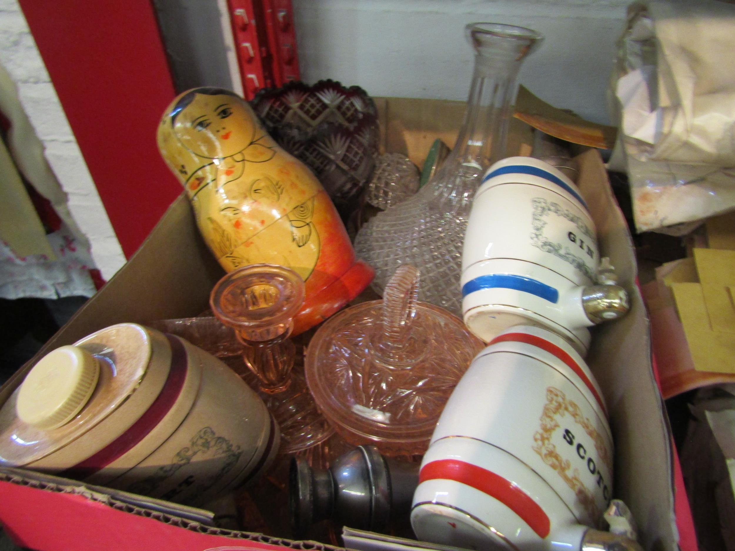 A box of miscellaneous including Wade flagons, ships decanter, filled silver candle holders, Russian