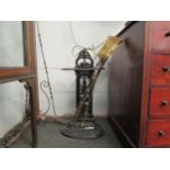 A Victorian cast iron stick stand, a three piece set of brass fire irons and a pair of 19th
