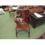 An early 19th Century yew and elm wheel-back Windsor armchair, the saddle seat on turned legs joined