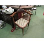 An Edwardian mahogany corner chair with silk upholstery on cross stretcher base