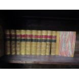 A collection of leather bound Charles Dickens novels with marbled edges and gilt lettering,