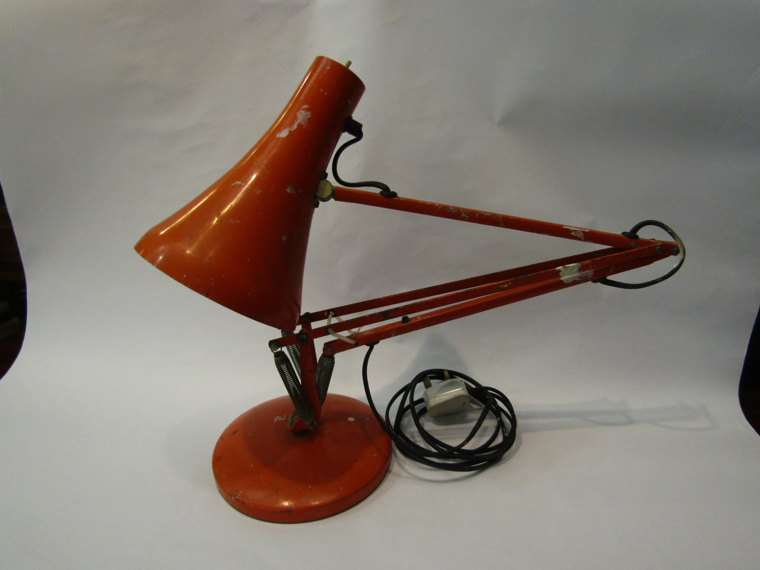 An Anglepoise lamp in orange, on circular base, a/f missing parts