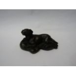 A resin bronze recumbent labrador, 15cm long