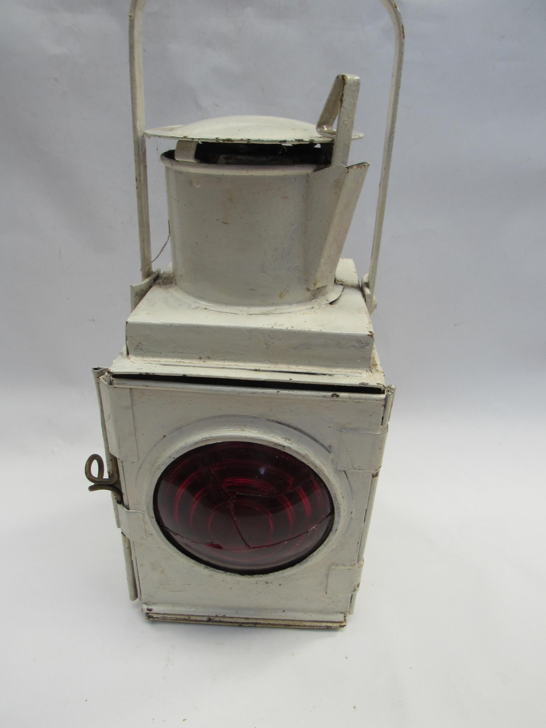 A white painted tail lamp with burner and resevoir, front lens a/f
