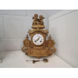 A late 19th Century French gilt ormolu mantel clock with Roman numeral hours and Arabic minutes. The